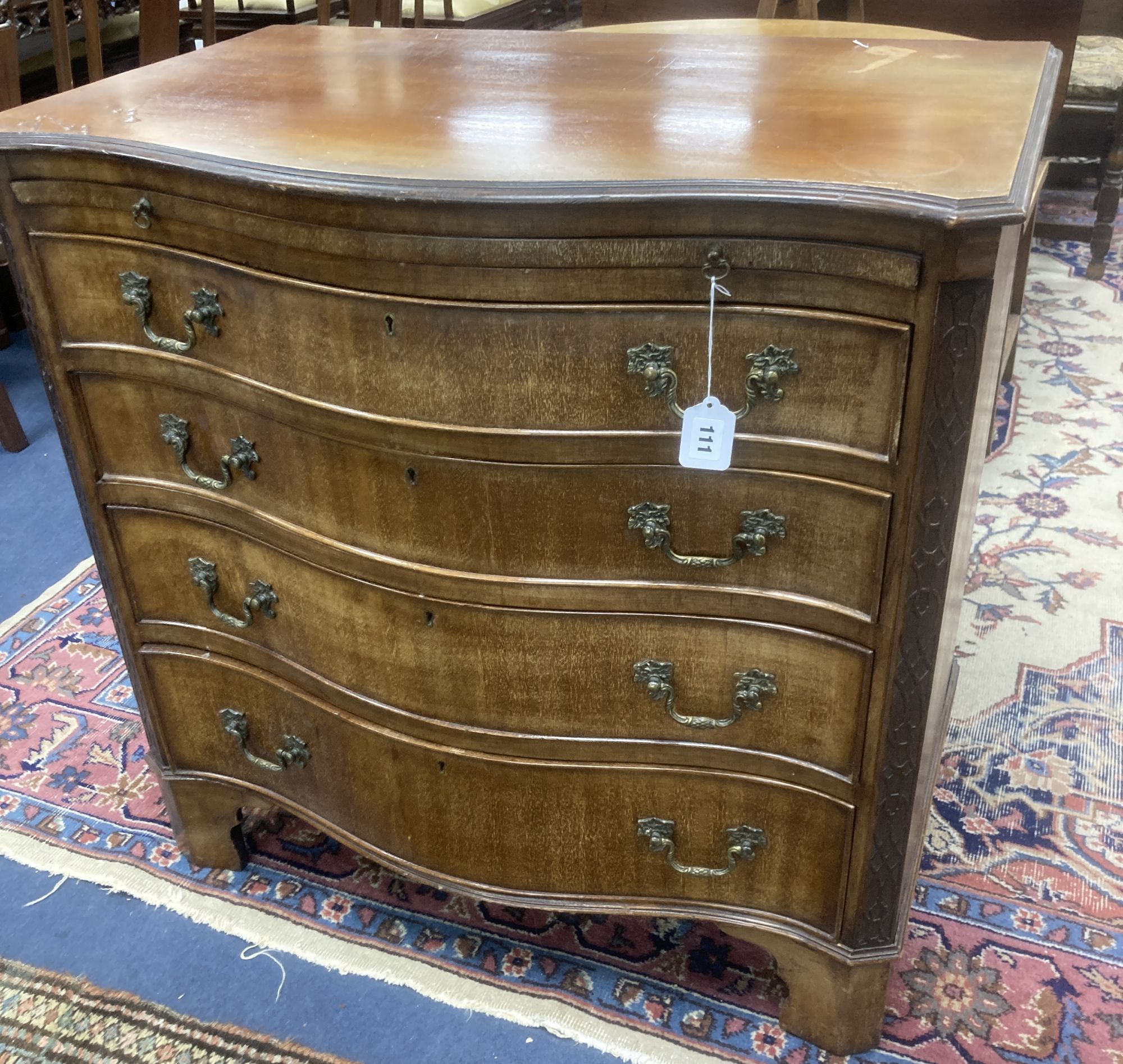 An early 20th century George III style mahogany serpentine chest of drawers with brushing slide, width 84cm, depth 54cm, height 83cm